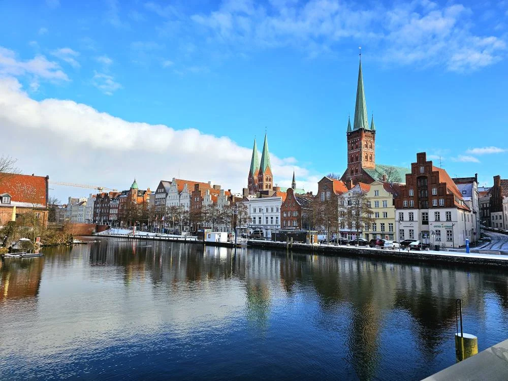 Cruising with Danny and Peter, MSC Cruises, MSC Preziosa, Hamburg, Germany, Lubeck City Tour showcasing the Holsten Gate, a historic medieval landmark with iconic round towers; St. Mary’s Church, known for its Gothic architecture and the world’s largest mechanical organ; charming cobblestone streets and UNESCO Heritage sites of Lubeck, reflecting its Hanseatic League history; traditional German lunch featuring bratwurst, sauerkraut, pretzels, and Lubeck’s famous marzipan, offering a taste of the city’s cultural and culinary heritage.