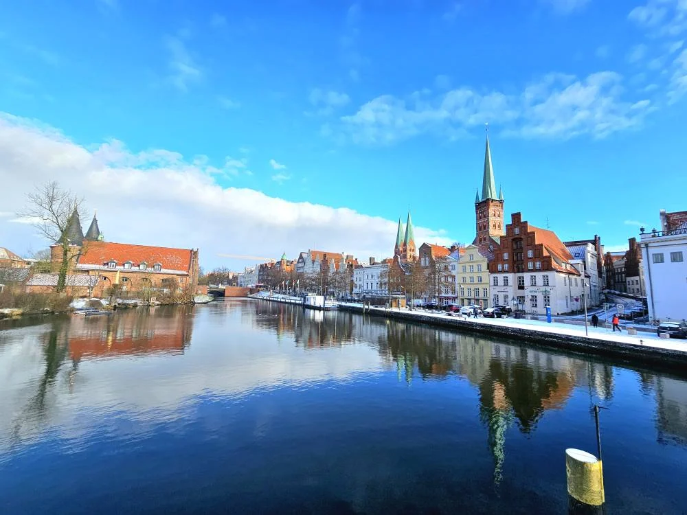 Cruising with Danny and Peter, MSC Cruises, MSC Preziosa, Hamburg, Germany, Lubeck City Tour showcasing the Holsten Gate, a historic medieval landmark with iconic round towers; St. Mary’s Church, known for its Gothic architecture and the world’s largest mechanical organ; charming cobblestone streets and UNESCO Heritage sites of Lubeck, reflecting its Hanseatic League history; traditional German lunch featuring bratwurst, sauerkraut, pretzels, and Lubeck’s famous marzipan, offering a taste of the city’s cultural and culinary heritage.
