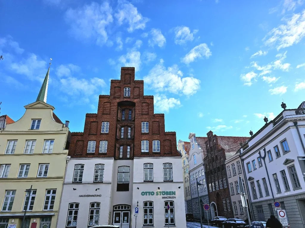 Cruising with Danny and Peter, MSC Cruises, MSC Preziosa, Hamburg, Germany, Lubeck City Tour showcasing the Holsten Gate, a historic medieval landmark with iconic round towers; St. Mary’s Church, known for its Gothic architecture and the world’s largest mechanical organ; charming cobblestone streets and UNESCO Heritage sites of Lubeck, reflecting its Hanseatic League history; traditional German lunch featuring bratwurst, sauerkraut, pretzels, and Lubeck’s famous marzipan, offering a taste of the city’s cultural and culinary heritage.