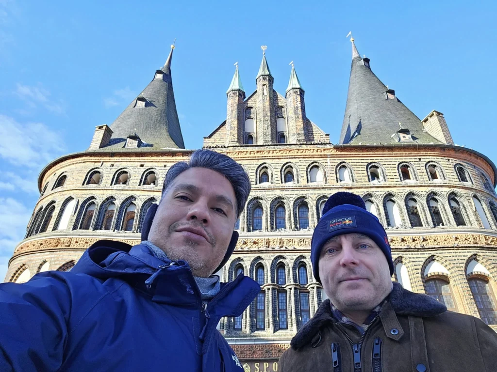 Cruising with Danny and Peter, MSC Cruises, MSC Preziosa, Hamburg, Germany, Lubeck City Tour showcasing the Holsten Gate, a historic medieval landmark with iconic round towers; St. Mary’s Church, known for its Gothic architecture and the world’s largest mechanical organ; charming cobblestone streets and UNESCO Heritage sites of Lubeck, reflecting its Hanseatic League history; traditional German lunch featuring bratwurst, sauerkraut, pretzels, and Lubeck’s famous marzipan, offering a taste of the city’s cultural and culinary heritage.