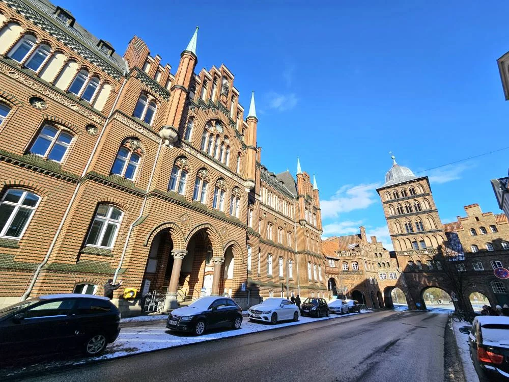 Cruising with Danny and Peter, MSC Cruises, MSC Preziosa, Hamburg, Germany, Lubeck City Tour showcasing the Holsten Gate, a historic medieval landmark with iconic round towers; St. Mary’s Church, known for its Gothic architecture and the world’s largest mechanical organ; charming cobblestone streets and UNESCO Heritage sites of Lubeck, reflecting its Hanseatic League history; traditional German lunch featuring bratwurst, sauerkraut, pretzels, and Lubeck’s famous marzipan, offering a taste of the city’s cultural and culinary heritage.
