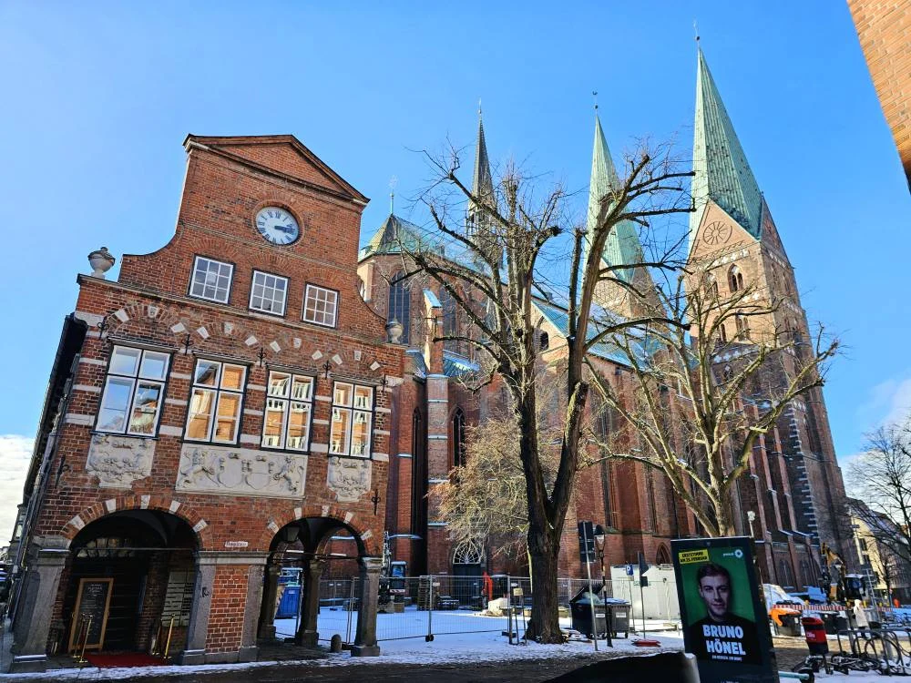 Cruising with Danny and Peter, MSC Cruises, MSC Preziosa, Hamburg, Germany, Lubeck City Tour showcasing the Holsten Gate, a historic medieval landmark with iconic round towers; St. Mary’s Church, known for its Gothic architecture and the world’s largest mechanical organ; charming cobblestone streets and UNESCO Heritage sites of Lubeck, reflecting its Hanseatic League history; traditional German lunch featuring bratwurst, sauerkraut, pretzels, and Lubeck’s famous marzipan, offering a taste of the city’s cultural and culinary heritage.