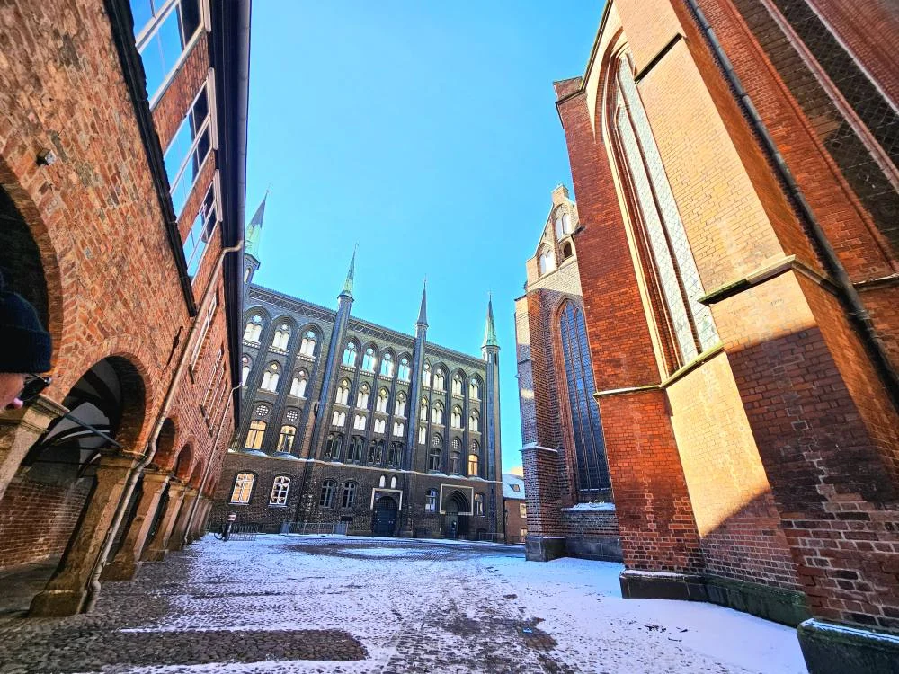 Cruising with Danny and Peter, MSC Cruises, MSC Preziosa, Hamburg, Germany, Lubeck City Tour showcasing the Holsten Gate, a historic medieval landmark with iconic round towers; St. Mary’s Church, known for its Gothic architecture and the world’s largest mechanical organ; charming cobblestone streets and UNESCO Heritage sites of Lubeck, reflecting its Hanseatic League history; traditional German lunch featuring bratwurst, sauerkraut, pretzels, and Lubeck’s famous marzipan, offering a taste of the city’s cultural and culinary heritage.