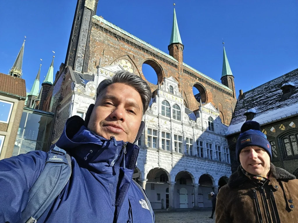 Cruising with Danny and Peter, MSC Cruises, MSC Preziosa, Hamburg, Germany, Lubeck City Tour showcasing the Holsten Gate, a historic medieval landmark with iconic round towers; St. Mary’s Church, known for its Gothic architecture and the world’s largest mechanical organ; charming cobblestone streets and UNESCO Heritage sites of Lubeck, reflecting its Hanseatic League history; traditional German lunch featuring bratwurst, sauerkraut, pretzels, and Lubeck’s famous marzipan, offering a taste of the city’s cultural and culinary heritage.