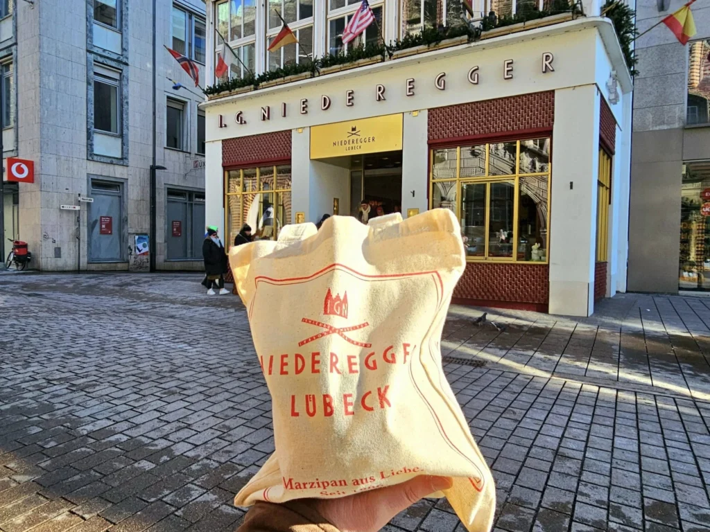 Cruising with Danny and Peter, MSC Cruises, MSC Preziosa, Hamburg, Germany, Lubeck City Tour showcasing the Holsten Gate, a historic medieval landmark with iconic round towers; St. Mary’s Church, known for its Gothic architecture and the world’s largest mechanical organ; charming cobblestone streets and UNESCO Heritage sites of Lubeck, reflecting its Hanseatic League history; traditional German lunch featuring bratwurst, sauerkraut, pretzels, and Lubeck’s famous marzipan, offering a taste of the city’s cultural and culinary heritage.