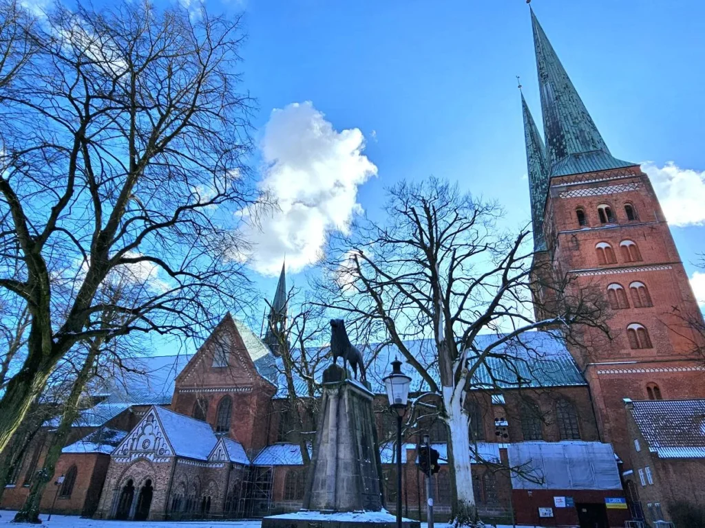 Cruising with Danny and Peter, MSC Cruises, MSC Preziosa, Hamburg, Germany, Lubeck City Tour showcasing the Holsten Gate, a historic medieval landmark with iconic round towers; St. Mary’s Church, known for its Gothic architecture and the world’s largest mechanical organ; charming cobblestone streets and UNESCO Heritage sites of Lubeck, reflecting its Hanseatic League history; traditional German lunch featuring bratwurst, sauerkraut, pretzels, and Lubeck’s famous marzipan, offering a taste of the city’s cultural and culinary heritage.