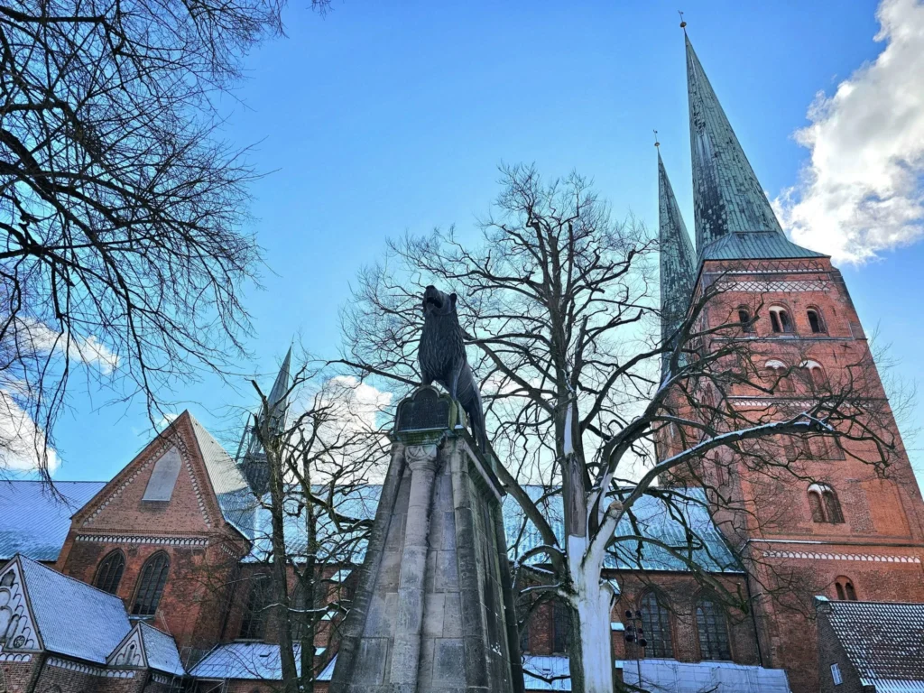 Cruising with Danny and Peter, MSC Cruises, MSC Preziosa, Hamburg, Germany, Lubeck City Tour showcasing the Holsten Gate, a historic medieval landmark with iconic round towers; St. Mary’s Church, known for its Gothic architecture and the world’s largest mechanical organ; charming cobblestone streets and UNESCO Heritage sites of Lubeck, reflecting its Hanseatic League history; traditional German lunch featuring bratwurst, sauerkraut, pretzels, and Lubeck’s famous marzipan, offering a taste of the city’s cultural and culinary heritage.