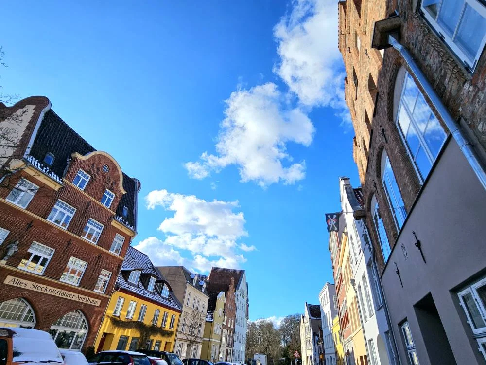 Cruising with Danny and Peter, MSC Cruises, MSC Preziosa, Hamburg, Germany, Lubeck City Tour showcasing the Holsten Gate, a historic medieval landmark with iconic round towers; St. Mary’s Church, known for its Gothic architecture and the world’s largest mechanical organ; charming cobblestone streets and UNESCO Heritage sites of Lubeck, reflecting its Hanseatic League history; traditional German lunch featuring bratwurst, sauerkraut, pretzels, and Lubeck’s famous marzipan, offering a taste of the city’s cultural and culinary heritage.