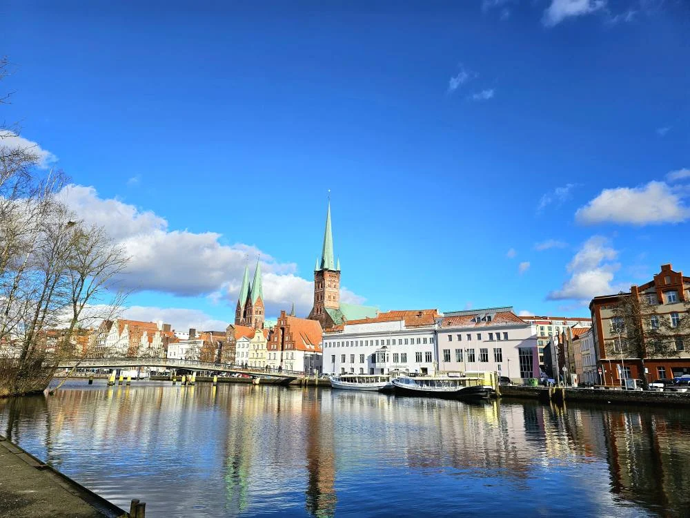 Cruising with Danny and Peter, MSC Cruises, MSC Preziosa, Hamburg, Germany, Lubeck City Tour showcasing the Holsten Gate, a historic medieval landmark with iconic round towers; St. Mary’s Church, known for its Gothic architecture and the world’s largest mechanical organ; charming cobblestone streets and UNESCO Heritage sites of Lubeck, reflecting its Hanseatic League history; traditional German lunch featuring bratwurst, sauerkraut, pretzels, and Lubeck’s famous marzipan, offering a taste of the city’s cultural and culinary heritage.