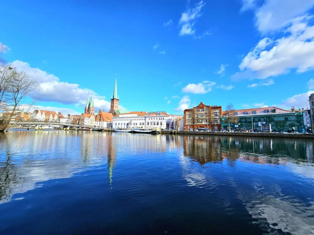 Cruising with Danny and Peter, MSC Cruises, MSC Preziosa, Hamburg, Germany, Lubeck City Tour showcasing the Holsten Gate, a historic medieval landmark with iconic round towers; St. Mary’s Church, known for its Gothic architecture and the world’s largest mechanical organ; charming cobblestone streets and UNESCO Heritage sites of Lubeck, reflecting its Hanseatic League history; traditional German lunch featuring bratwurst, sauerkraut, pretzels, and Lubeck’s famous marzipan, offering a taste of the city’s cultural and culinary heritage.