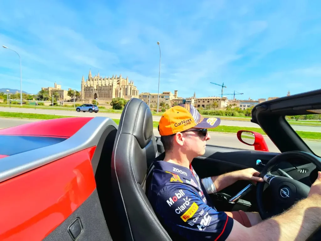 Cruising with Danny and Peter, Holland America Line, Nieuw Statendam, Palma de Mallorca, Spain | Scenic coastal drive in Mallorca during the Palma de Mallorca Sunset Tour, featuring rugged cliffs and azure waters. Historic Palma Cathedral with Gothic architecture is also highlighted. The luxurious seafood feast aboard MS Nieuw Statendam includes lobster, shrimp, and crab, complemented by a stunning Mediterranean sunset with pink and gold hues in the sky.