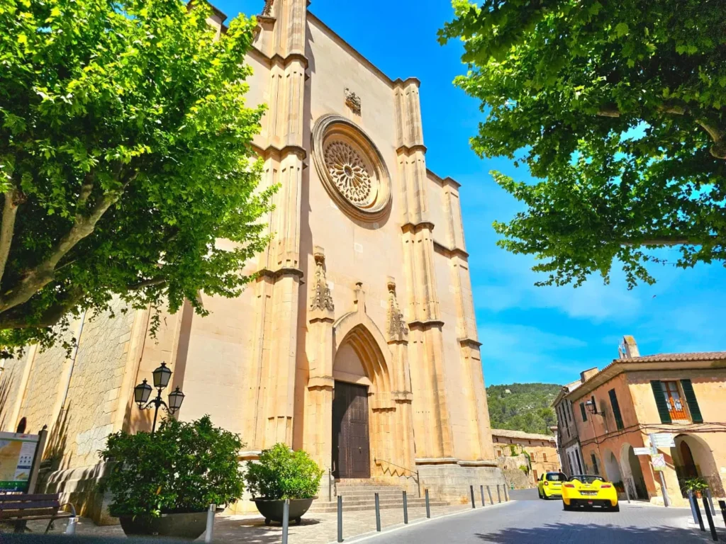 Cruising with Danny and Peter, Holland America Line, Nieuw Statendam, Palma de Mallorca, Spain | Scenic coastal drive in Mallorca during the Palma de Mallorca Sunset Tour, featuring rugged cliffs and azure waters. Historic Palma Cathedral with Gothic architecture is also highlighted. The luxurious seafood feast aboard MS Nieuw Statendam includes lobster, shrimp, and crab, complemented by a stunning Mediterranean sunset with pink and gold hues in the sky.