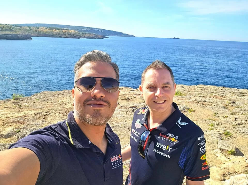 Cruising with Danny and Peter, Holland America Line, Nieuw Statendam, Palma de Mallorca, Spain | Scenic coastal drive in Mallorca during the Palma de Mallorca Sunset Tour, featuring rugged cliffs and azure waters. Historic Palma Cathedral with Gothic architecture is also highlighted. The luxurious seafood feast aboard MS Nieuw Statendam includes lobster, shrimp, and crab, complemented by a stunning Mediterranean sunset with pink and gold hues in the sky.