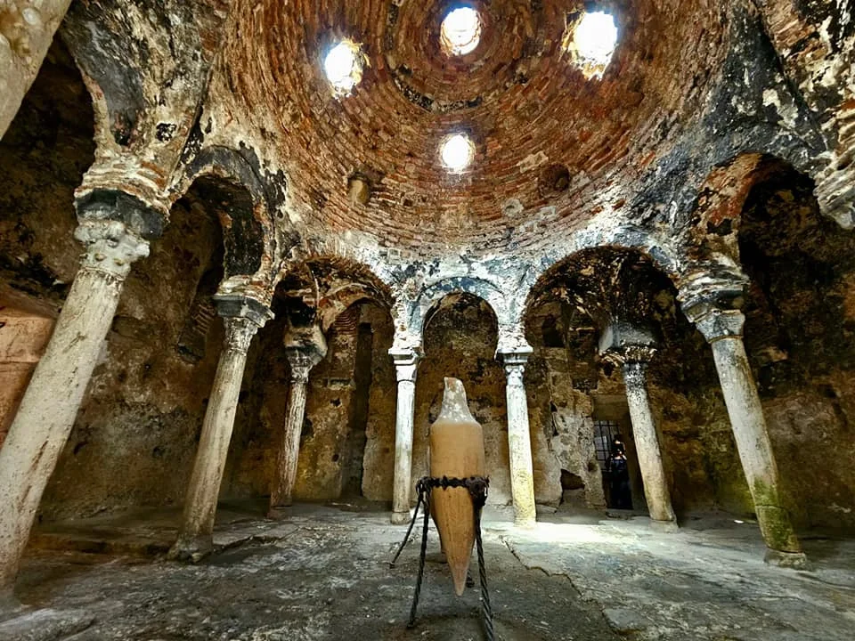 Cruising with Danny and Peter, Holland America Line, Nieuw Statendam, Palma de Mallorca, Spain | Scenic coastal drive in Mallorca during the Palma de Mallorca Sunset Tour, featuring rugged cliffs and azure waters. Historic Palma Cathedral with Gothic architecture is also highlighted. The luxurious seafood feast aboard MS Nieuw Statendam includes lobster, shrimp, and crab, complemented by a stunning Mediterranean sunset with pink and gold hues in the sky.