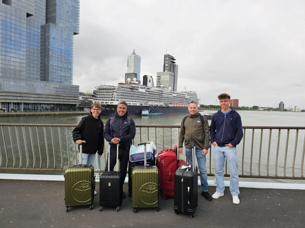 Cruising with Danny and Peter, Holland America Line, Nieuw Statendam, Rotterdam, The Netherlands, Canary Islands Adventure | A vibrant collage captures a family’s adventure on Holland America’s Nieuw Statendam during the Canary Island Enchantment cruise. The journey begins in Rotterdam, Netherlands, with the sleek ship docked against the city’s modern skyline, featuring the Erasmus Bridge. Onboard, the elegant atrium glows with Dutch-inspired decor, while the cozy Oceanview Family Cabin offers serene ocean views. The Lido Pool sparkles under the sun, and the Crow’s Nest provides panoramic vistas. In Agadir, Morocco, vibrant Souk El Had stalls overflow with colorful spices and crafts, and camel rides evoke Berber traditions. Lanzarote’s Cueva de los Verdes showcases dramatic lava tube formations, while Jameos del Agua features a surreal volcanic cave with a turquoise lake. Tenerife’s Anaga Rural Park displays misty laurel forests, and Playa de las Teresitas glows with golden sands. In Funchal, Madeira, a trike tour winds through banana fields, with Cabo Girão’s glass skywalk offering stunning cliff views. Porto’s rainy Ribeira District shines with colorful buildings and azulejo tiles at São Bento Station. In London, a black cab tour passes the iconic Tower Bridge and Buckingham Palace. The cruise ends with a serene sail-away past Dover’s White Cliffs, followed by a heartfelt family reunion in Rotterdam’s Zalmhaventoren apartment, with the city’s skyline in the background.