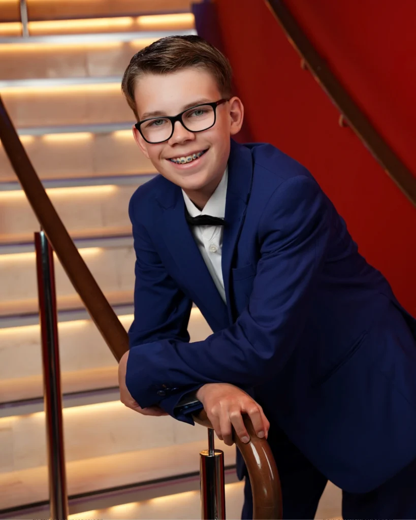 Cruising with Danny and Peter, Holland America Line, Nieuw Statendam, Rotterdam, The Netherlands, Canary Islands Adventure | A vibrant collage captures a family’s adventure on Holland America’s Nieuw Statendam during the Canary Island Enchantment cruise. The journey begins in Rotterdam, Netherlands, with the sleek ship docked against the city’s modern skyline, featuring the Erasmus Bridge. Onboard, the elegant atrium glows with Dutch-inspired decor, while the cozy Oceanview Family Cabin offers serene ocean views. The Lido Pool sparkles under the sun, and the Crow’s Nest provides panoramic vistas. In Agadir, Morocco, vibrant Souk El Had stalls overflow with colorful spices and crafts, and camel rides evoke Berber traditions. Lanzarote’s Cueva de los Verdes showcases dramatic lava tube formations, while Jameos del Agua features a surreal volcanic cave with a turquoise lake. Tenerife’s Anaga Rural Park displays misty laurel forests, and Playa de las Teresitas glows with golden sands. In Funchal, Madeira, a trike tour winds through banana fields, with Cabo Girão’s glass skywalk offering stunning cliff views. Porto’s rainy Ribeira District shines with colorful buildings and azulejo tiles at São Bento Station. In London, a black cab tour passes the iconic Tower Bridge and Buckingham Palace. The cruise ends with a serene sail-away past Dover’s White Cliffs, followed by a heartfelt family reunion in Rotterdam’s Zalmhaventoren apartment, with the city’s skyline in the background.