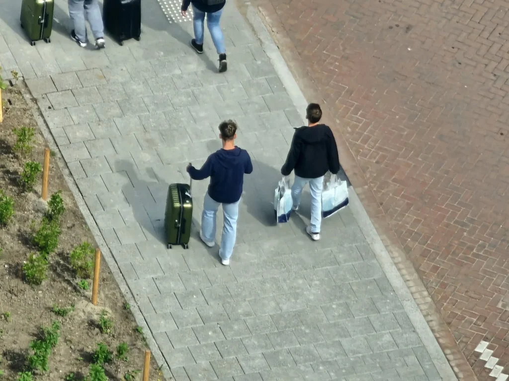 Cruising with Danny and Peter, Holland America Line, Nieuw Statendam, Rotterdam, The Netherlands, Canary Islands Adventure | A vibrant collage captures a family’s adventure on Holland America’s Nieuw Statendam during the Canary Island Enchantment cruise. The journey begins in Rotterdam, Netherlands, with the sleek ship docked against the city’s modern skyline, featuring the Erasmus Bridge. Onboard, the elegant atrium glows with Dutch-inspired decor, while the cozy Oceanview Family Cabin offers serene ocean views. The Lido Pool sparkles under the sun, and the Crow’s Nest provides panoramic vistas. In Agadir, Morocco, vibrant Souk El Had stalls overflow with colorful spices and crafts, and camel rides evoke Berber traditions. Lanzarote’s Cueva de los Verdes showcases dramatic lava tube formations, while Jameos del Agua features a surreal volcanic cave with a turquoise lake. Tenerife’s Anaga Rural Park displays misty laurel forests, and Playa de las Teresitas glows with golden sands. In Funchal, Madeira, a trike tour winds through banana fields, with Cabo Girão’s glass skywalk offering stunning cliff views. Porto’s rainy Ribeira District shines with colorful buildings and azulejo tiles at São Bento Station. In London, a black cab tour passes the iconic Tower Bridge and Buckingham Palace. The cruise ends with a serene sail-away past Dover’s White Cliffs, followed by a heartfelt family reunion in Rotterdam’s Zalmhaventoren apartment, with the city’s skyline in the background.