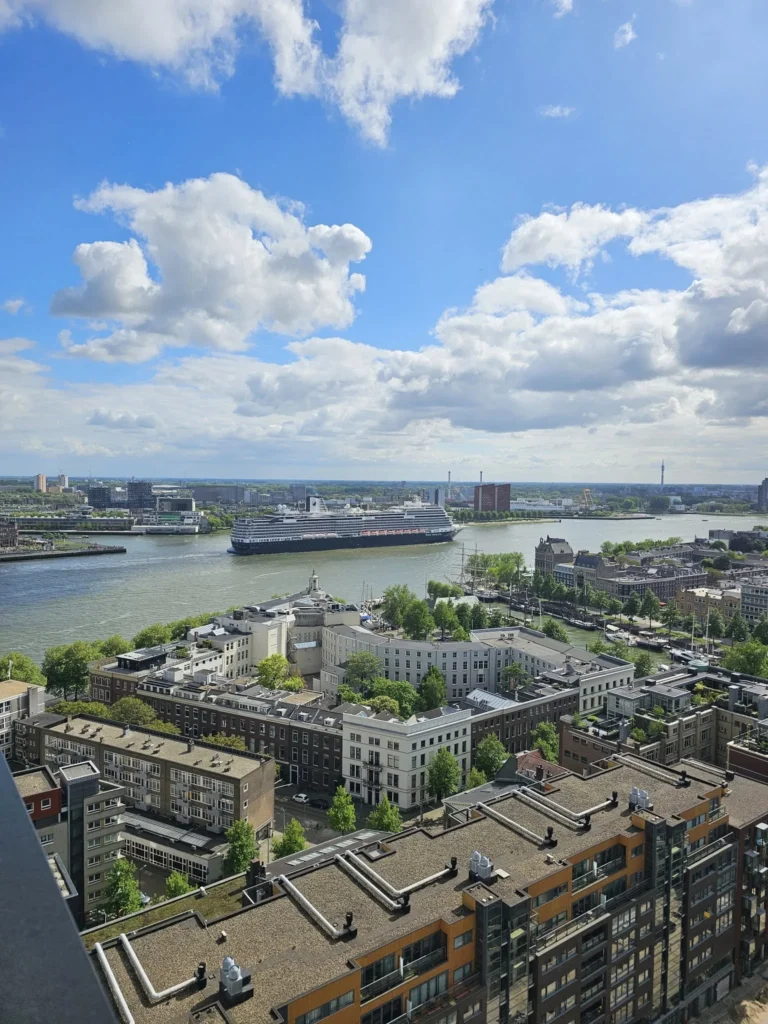 Cruising with Danny and Peter, Holland America Line, Nieuw Statendam, Rotterdam, The Netherlands, Canary Islands Adventure | A vibrant collage captures a family’s adventure on Holland America’s Nieuw Statendam during the Canary Island Enchantment cruise. The journey begins in Rotterdam, Netherlands, with the sleek ship docked against the city’s modern skyline, featuring the Erasmus Bridge. Onboard, the elegant atrium glows with Dutch-inspired decor, while the cozy Oceanview Family Cabin offers serene ocean views. The Lido Pool sparkles under the sun, and the Crow’s Nest provides panoramic vistas. In Agadir, Morocco, vibrant Souk El Had stalls overflow with colorful spices and crafts, and camel rides evoke Berber traditions. Lanzarote’s Cueva de los Verdes showcases dramatic lava tube formations, while Jameos del Agua features a surreal volcanic cave with a turquoise lake. Tenerife’s Anaga Rural Park displays misty laurel forests, and Playa de las Teresitas glows with golden sands. In Funchal, Madeira, a trike tour winds through banana fields, with Cabo Girão’s glass skywalk offering stunning cliff views. Porto’s rainy Ribeira District shines with colorful buildings and azulejo tiles at São Bento Station. In London, a black cab tour passes the iconic Tower Bridge and Buckingham Palace. The cruise ends with a serene sail-away past Dover’s White Cliffs, followed by a heartfelt family reunion in Rotterdam’s Zalmhaventoren apartment, with the city’s skyline in the background.