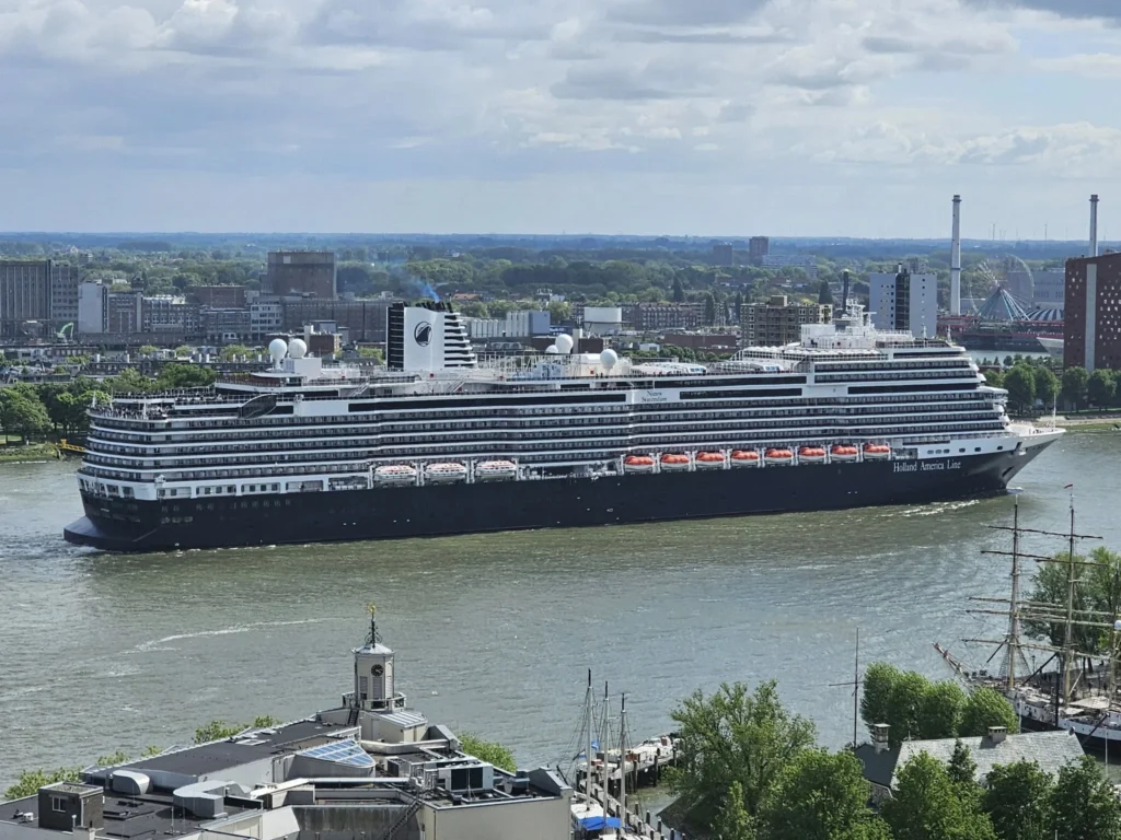 Cruising with Danny and Peter, Holland America Line, Nieuw Statendam, Rotterdam, The Netherlands, Canary Islands Adventure | A vibrant collage captures a family’s adventure on Holland America’s Nieuw Statendam during the Canary Island Enchantment cruise. The journey begins in Rotterdam, Netherlands, with the sleek ship docked against the city’s modern skyline, featuring the Erasmus Bridge. Onboard, the elegant atrium glows with Dutch-inspired decor, while the cozy Oceanview Family Cabin offers serene ocean views. The Lido Pool sparkles under the sun, and the Crow’s Nest provides panoramic vistas. In Agadir, Morocco, vibrant Souk El Had stalls overflow with colorful spices and crafts, and camel rides evoke Berber traditions. Lanzarote’s Cueva de los Verdes showcases dramatic lava tube formations, while Jameos del Agua features a surreal volcanic cave with a turquoise lake. Tenerife’s Anaga Rural Park displays misty laurel forests, and Playa de las Teresitas glows with golden sands. In Funchal, Madeira, a trike tour winds through banana fields, with Cabo Girão’s glass skywalk offering stunning cliff views. Porto’s rainy Ribeira District shines with colorful buildings and azulejo tiles at São Bento Station. In London, a black cab tour passes the iconic Tower Bridge and Buckingham Palace. The cruise ends with a serene sail-away past Dover’s White Cliffs, followed by a heartfelt family reunion in Rotterdam’s Zalmhaventoren apartment, with the city’s skyline in the background.