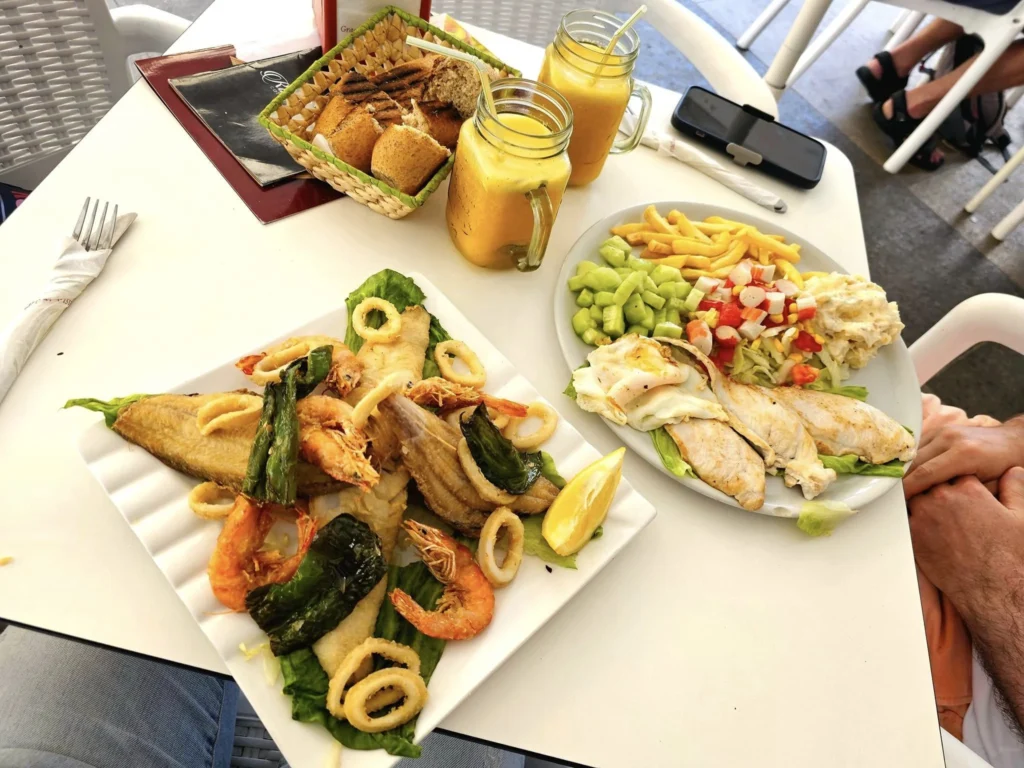 Cruising with Danny and Peter, Holland America Line, Nieuw Statendam, Ceuta, Spanish Morocco, Spain | Travelers on a Ceuta Heritage Tour with Holland America Line explore the historic Royal Walls and enjoy breathtaking panoramic views, while savoring North African dishes at Cafeteria Rotterdam during their Mediterranean culinary journey.