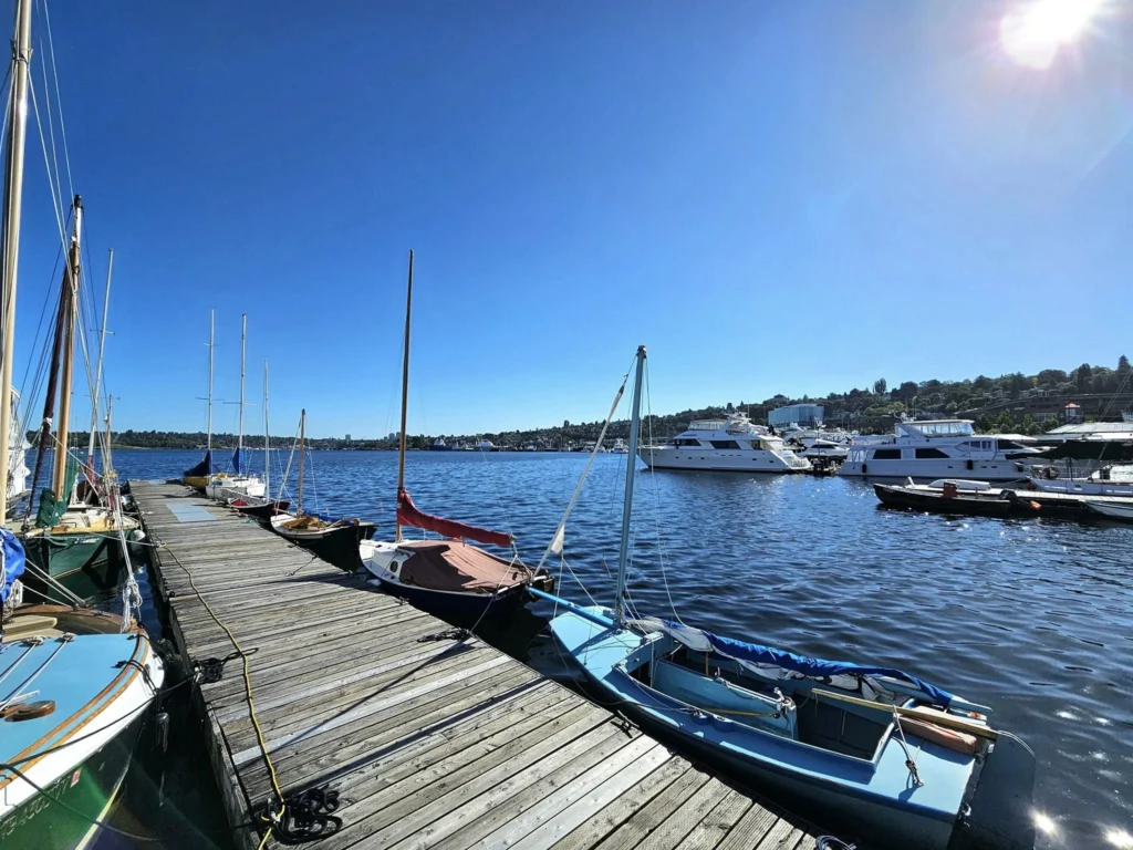 Cruising with Danny and Peter, Holland America Line, Westerdam, Seattle, Washington, United States, Day Trip Arctic Cruise | A vibrant collage capturing a day in Seattle, showcasing Lake Union’s serene waters reflecting the misty skyline with houseboats and kayakers, the towering Space Needle offering panoramic views of Puget Sound and Mount Rainier, and Chihuly Garden and Glass’s colorful glass sculptures blending with lush greenery. Pike Place Market buzzes with vendors tossing salmon and stalls brimming with flowers and artisanal goods under the iconic red sign. A cozy table at Villa Escondida displays tacos al pastor and enchiladas in a warm, mural-lined setting. The Seattle Great Wheel rises above Elliott Bay’s sparkling waterfront, while the Washington Park Arboretum’s tranquil paths feature blooming rhododendrons and a heron by a pond. The Japanese Garden’s koi pond, curved bridge, and stone lanterns create a Zen oasis, all set against Seattle’s dynamic blend of urban and natural beauty.