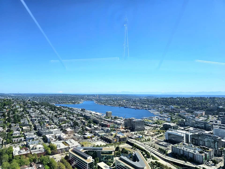 Cruising with Danny and Peter, Holland America Line, Westerdam, Seattle, Washington, United States, Day Trip Arctic Cruise | A vibrant collage capturing a day in Seattle, showcasing Lake Union’s serene waters reflecting the misty skyline with houseboats and kayakers, the towering Space Needle offering panoramic views of Puget Sound and Mount Rainier, and Chihuly Garden and Glass’s colorful glass sculptures blending with lush greenery. Pike Place Market buzzes with vendors tossing salmon and stalls brimming with flowers and artisanal goods under the iconic red sign. A cozy table at Villa Escondida displays tacos al pastor and enchiladas in a warm, mural-lined setting. The Seattle Great Wheel rises above Elliott Bay’s sparkling waterfront, while the Washington Park Arboretum’s tranquil paths feature blooming rhododendrons and a heron by a pond. The Japanese Garden’s koi pond, curved bridge, and stone lanterns create a Zen oasis, all set against Seattle’s dynamic blend of urban and natural beauty.