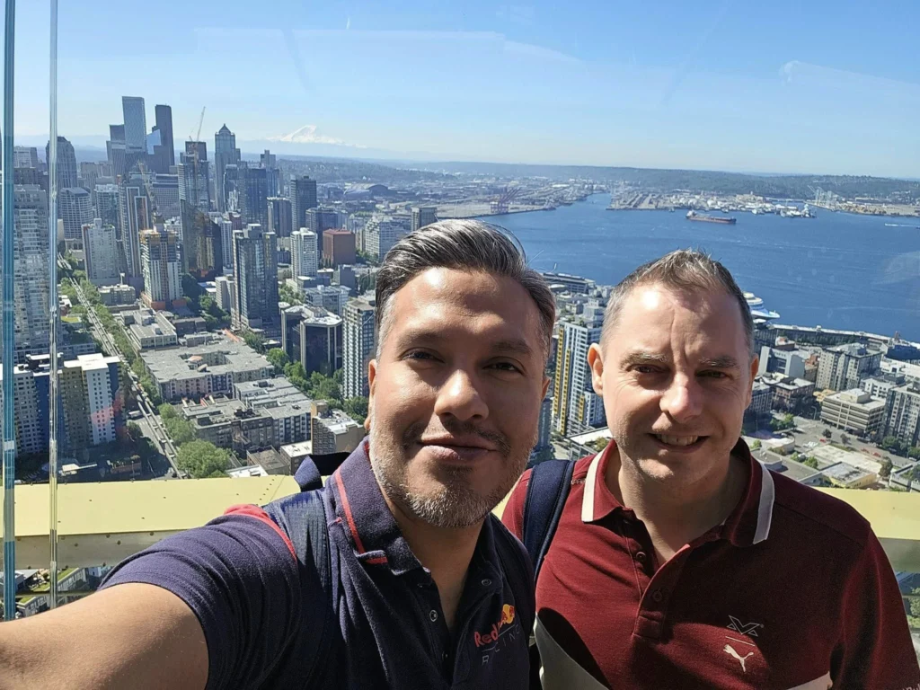 Cruising with Danny and Peter, Holland America Line, Westerdam, Seattle, Washington, United States, Day Trip Arctic Cruise | A vibrant collage capturing a day in Seattle, showcasing Lake Union’s serene waters reflecting the misty skyline with houseboats and kayakers, the towering Space Needle offering panoramic views of Puget Sound and Mount Rainier, and Chihuly Garden and Glass’s colorful glass sculptures blending with lush greenery. Pike Place Market buzzes with vendors tossing salmon and stalls brimming with flowers and artisanal goods under the iconic red sign. A cozy table at Villa Escondida displays tacos al pastor and enchiladas in a warm, mural-lined setting. The Seattle Great Wheel rises above Elliott Bay’s sparkling waterfront, while the Washington Park Arboretum’s tranquil paths feature blooming rhododendrons and a heron by a pond. The Japanese Garden’s koi pond, curved bridge, and stone lanterns create a Zen oasis, all set against Seattle’s dynamic blend of urban and natural beauty.