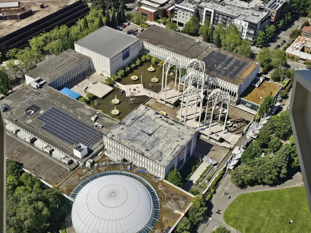 Cruising with Danny and Peter, Holland America Line, Westerdam, Seattle, Washington, United States, Day Trip Arctic Cruise | A vibrant collage capturing a day in Seattle, showcasing Lake Union’s serene waters reflecting the misty skyline with houseboats and kayakers, the towering Space Needle offering panoramic views of Puget Sound and Mount Rainier, and Chihuly Garden and Glass’s colorful glass sculptures blending with lush greenery. Pike Place Market buzzes with vendors tossing salmon and stalls brimming with flowers and artisanal goods under the iconic red sign. A cozy table at Villa Escondida displays tacos al pastor and enchiladas in a warm, mural-lined setting. The Seattle Great Wheel rises above Elliott Bay’s sparkling waterfront, while the Washington Park Arboretum’s tranquil paths feature blooming rhododendrons and a heron by a pond. The Japanese Garden’s koi pond, curved bridge, and stone lanterns create a Zen oasis, all set against Seattle’s dynamic blend of urban and natural beauty.