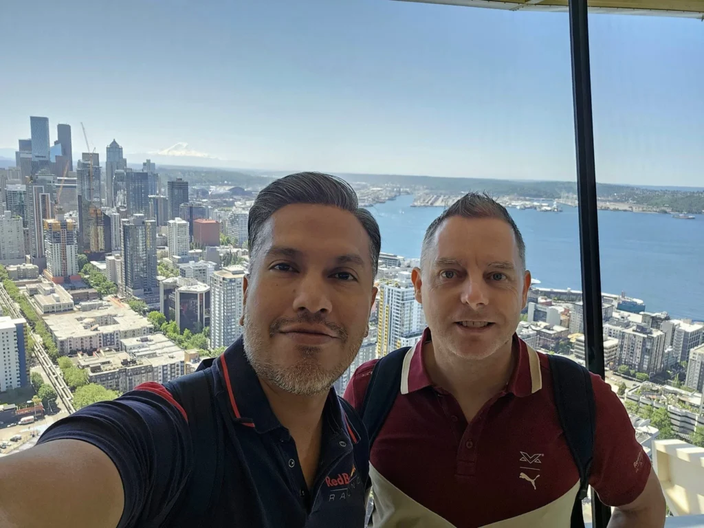 Cruising with Danny and Peter, Holland America Line, Westerdam, Seattle, Washington, United States, Day Trip Arctic Cruise | A vibrant collage capturing a day in Seattle, showcasing Lake Union’s serene waters reflecting the misty skyline with houseboats and kayakers, the towering Space Needle offering panoramic views of Puget Sound and Mount Rainier, and Chihuly Garden and Glass’s colorful glass sculptures blending with lush greenery. Pike Place Market buzzes with vendors tossing salmon and stalls brimming with flowers and artisanal goods under the iconic red sign. A cozy table at Villa Escondida displays tacos al pastor and enchiladas in a warm, mural-lined setting. The Seattle Great Wheel rises above Elliott Bay’s sparkling waterfront, while the Washington Park Arboretum’s tranquil paths feature blooming rhododendrons and a heron by a pond. The Japanese Garden’s koi pond, curved bridge, and stone lanterns create a Zen oasis, all set against Seattle’s dynamic blend of urban and natural beauty.