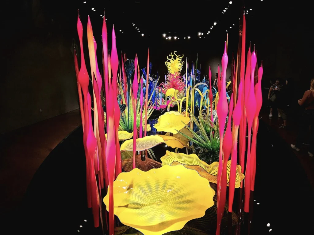 Cruising with Danny and Peter, Holland America Line, Westerdam, Seattle, Washington, United States, Day Trip Arctic Cruise | A vibrant collage capturing a day in Seattle, showcasing Lake Union’s serene waters reflecting the misty skyline with houseboats and kayakers, the towering Space Needle offering panoramic views of Puget Sound and Mount Rainier, and Chihuly Garden and Glass’s colorful glass sculptures blending with lush greenery. Pike Place Market buzzes with vendors tossing salmon and stalls brimming with flowers and artisanal goods under the iconic red sign. A cozy table at Villa Escondida displays tacos al pastor and enchiladas in a warm, mural-lined setting. The Seattle Great Wheel rises above Elliott Bay’s sparkling waterfront, while the Washington Park Arboretum’s tranquil paths feature blooming rhododendrons and a heron by a pond. The Japanese Garden’s koi pond, curved bridge, and stone lanterns create a Zen oasis, all set against Seattle’s dynamic blend of urban and natural beauty.