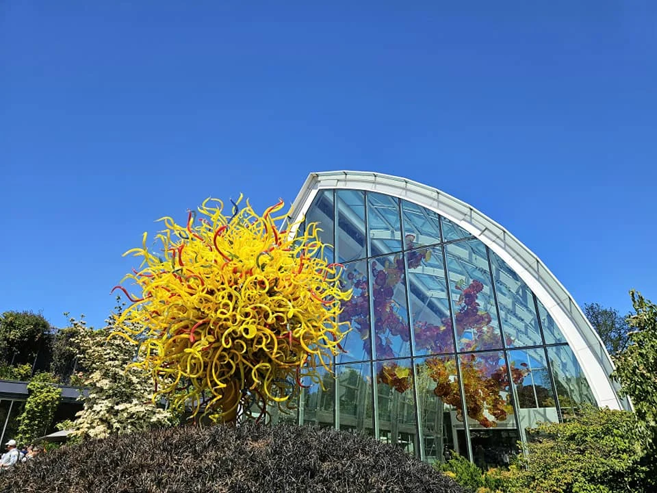 Cruising with Danny and Peter, Holland America Line, Westerdam, Seattle, Washington, United States, Day Trip Arctic Cruise | A vibrant collage capturing a day in Seattle, showcasing Lake Union’s serene waters reflecting the misty skyline with houseboats and kayakers, the towering Space Needle offering panoramic views of Puget Sound and Mount Rainier, and Chihuly Garden and Glass’s colorful glass sculptures blending with lush greenery. Pike Place Market buzzes with vendors tossing salmon and stalls brimming with flowers and artisanal goods under the iconic red sign. A cozy table at Villa Escondida displays tacos al pastor and enchiladas in a warm, mural-lined setting. The Seattle Great Wheel rises above Elliott Bay’s sparkling waterfront, while the Washington Park Arboretum’s tranquil paths feature blooming rhododendrons and a heron by a pond. The Japanese Garden’s koi pond, curved bridge, and stone lanterns create a Zen oasis, all set against Seattle’s dynamic blend of urban and natural beauty.