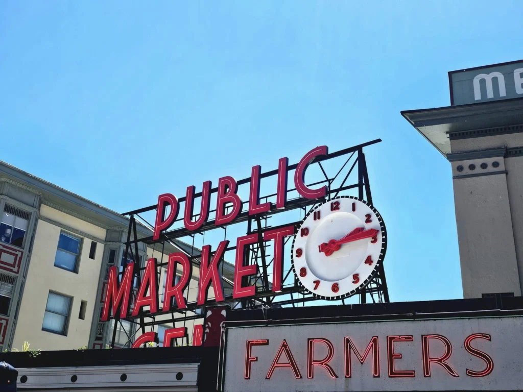 Cruising with Danny and Peter, Holland America Line, Westerdam, Seattle, Washington, United States, Day Trip Arctic Cruise | A vibrant collage capturing a day in Seattle, showcasing Lake Union’s serene waters reflecting the misty skyline with houseboats and kayakers, the towering Space Needle offering panoramic views of Puget Sound and Mount Rainier, and Chihuly Garden and Glass’s colorful glass sculptures blending with lush greenery. Pike Place Market buzzes with vendors tossing salmon and stalls brimming with flowers and artisanal goods under the iconic red sign. A cozy table at Villa Escondida displays tacos al pastor and enchiladas in a warm, mural-lined setting. The Seattle Great Wheel rises above Elliott Bay’s sparkling waterfront, while the Washington Park Arboretum’s tranquil paths feature blooming rhododendrons and a heron by a pond. The Japanese Garden’s koi pond, curved bridge, and stone lanterns create a Zen oasis, all set against Seattle’s dynamic blend of urban and natural beauty.