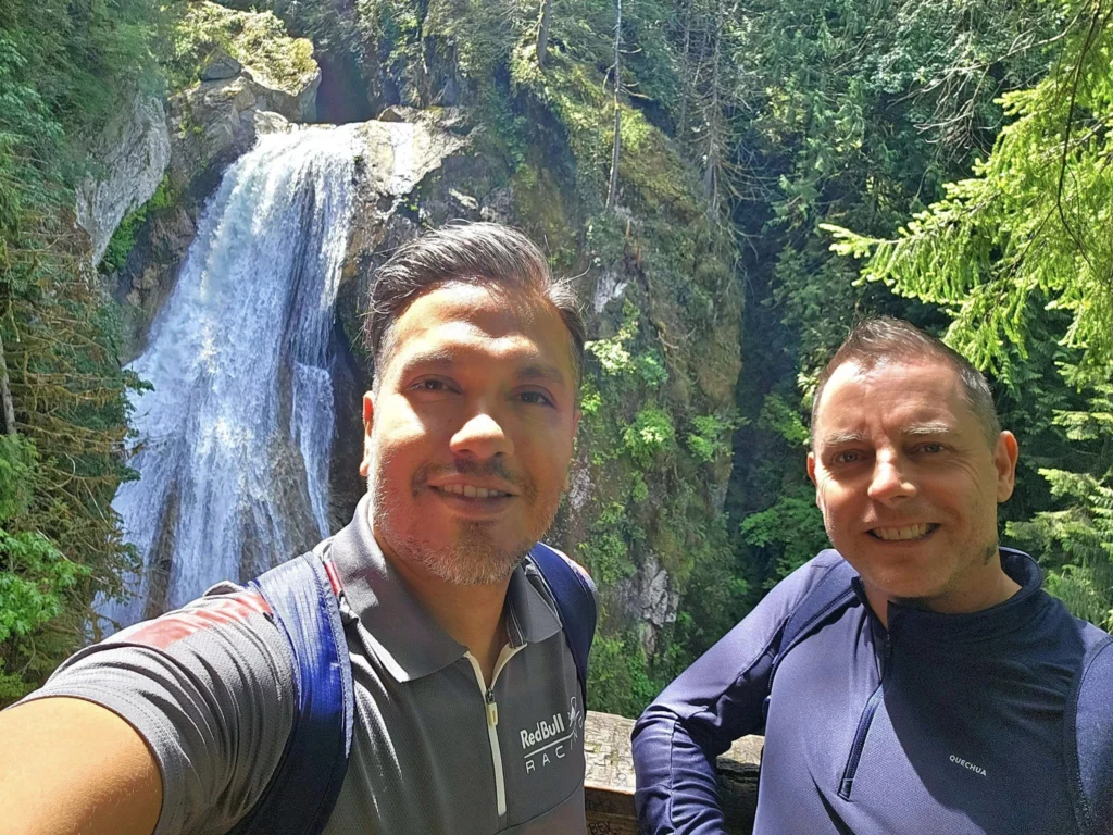 Cruising with Danny and Peter, Holland America Line, Westerdam, Seattle, Washington, United States, Day Trip Waterfalls History | A vibrant collage captures a day in Seattle’s Pacific Northwest Waterfalls Tour, showcasing Pike Place Market’s bustling scene with fishmongers tossing salmon and colorful flower stalls under the iconic red neon sign, set against Puget Sound’s waterfront; Twin Falls cascading over mossy cliffs into a misty pool, surrounded by old-growth evergreens in Olallie State Park, with sunlight filtering through the canopy; North Bend’s retro Twin Peaks diner with its glowing neon sign and quaint main street, framed by rolling hills and the Cascade Mountains; the majestic 270-foot Snoqualmie Falls roaring into a misty pool, with rainbows shimmering in the sunlight and a wooden viewing platform overlooking the lush Snoqualmie Valley; Snoqualmie’s historic district, featuring the Northwest Railway Museum’s vintage locomotives and charming shops lined with old-fashioned street lamps; Borst Lake’s serene waters reflecting Mount Si’s snow-capped peak, with a heron at the edge and evergreen forests under a soft morning mist; and the Museum of Flight’s sleek Concorde and Air Force One jets displayed in a spacious hangar, alongside interactive simulators and a replica of the International Space Station, showcasing Seattle’s aviation heritage.