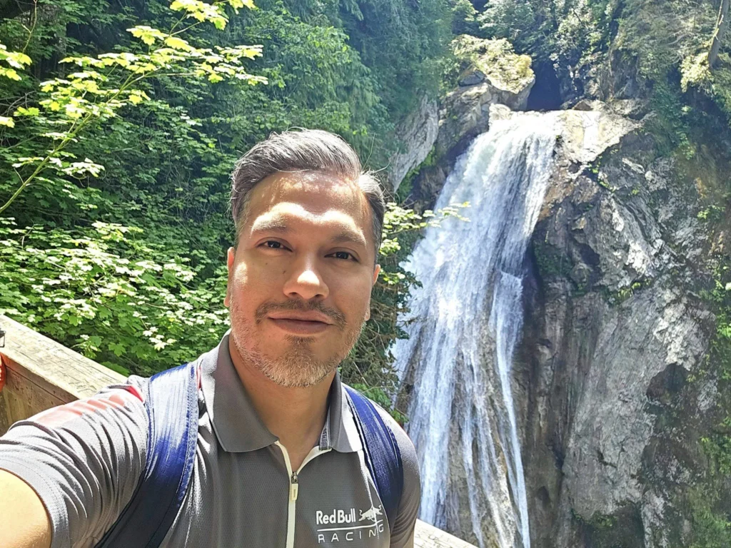 Cruising with Danny and Peter, Holland America Line, Westerdam, Seattle, Washington, United States, Day Trip Waterfalls History | A vibrant collage captures a day in Seattle’s Pacific Northwest Waterfalls Tour, showcasing Pike Place Market’s bustling scene with fishmongers tossing salmon and colorful flower stalls under the iconic red neon sign, set against Puget Sound’s waterfront; Twin Falls cascading over mossy cliffs into a misty pool, surrounded by old-growth evergreens in Olallie State Park, with sunlight filtering through the canopy; North Bend’s retro Twin Peaks diner with its glowing neon sign and quaint main street, framed by rolling hills and the Cascade Mountains; the majestic 270-foot Snoqualmie Falls roaring into a misty pool, with rainbows shimmering in the sunlight and a wooden viewing platform overlooking the lush Snoqualmie Valley; Snoqualmie’s historic district, featuring the Northwest Railway Museum’s vintage locomotives and charming shops lined with old-fashioned street lamps; Borst Lake’s serene waters reflecting Mount Si’s snow-capped peak, with a heron at the edge and evergreen forests under a soft morning mist; and the Museum of Flight’s sleek Concorde and Air Force One jets displayed in a spacious hangar, alongside interactive simulators and a replica of the International Space Station, showcasing Seattle’s aviation heritage.