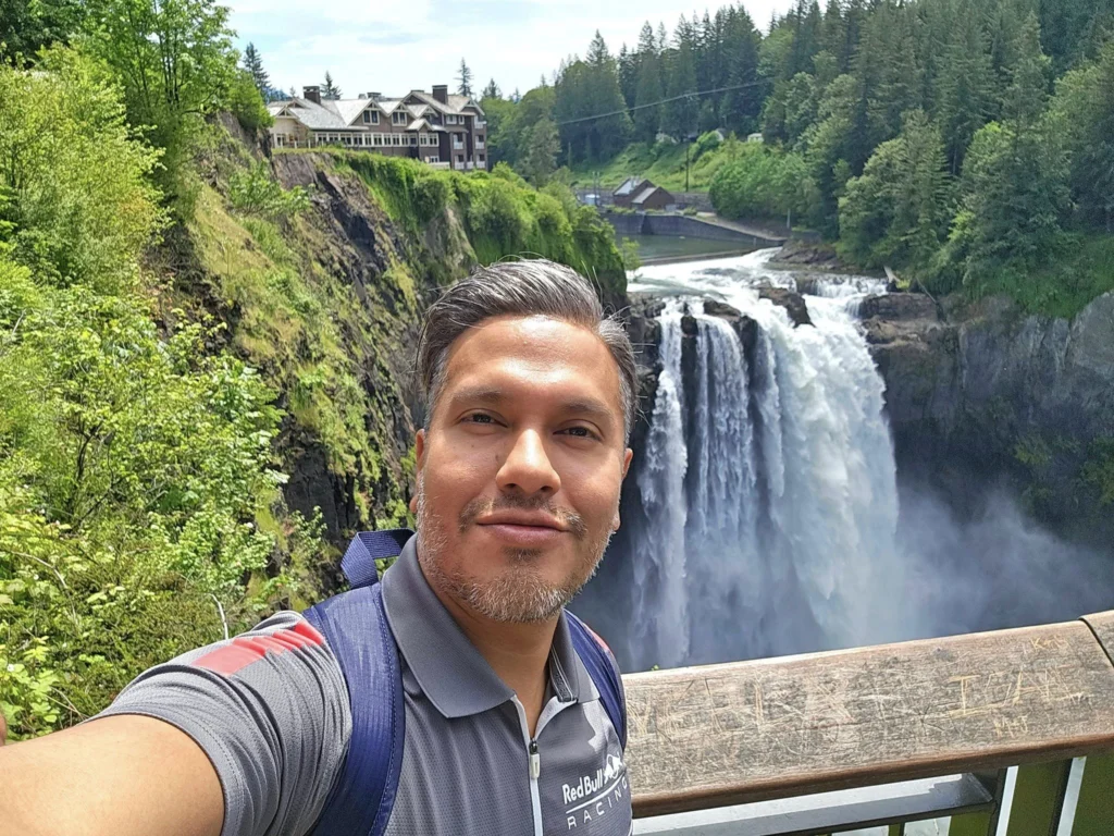 Cruising with Danny and Peter, Holland America Line, Westerdam, Seattle, Washington, United States, Day Trip Waterfalls History | A vibrant collage captures a day in Seattle’s Pacific Northwest Waterfalls Tour, showcasing Pike Place Market’s bustling scene with fishmongers tossing salmon and colorful flower stalls under the iconic red neon sign, set against Puget Sound’s waterfront; Twin Falls cascading over mossy cliffs into a misty pool, surrounded by old-growth evergreens in Olallie State Park, with sunlight filtering through the canopy; North Bend’s retro Twin Peaks diner with its glowing neon sign and quaint main street, framed by rolling hills and the Cascade Mountains; the majestic 270-foot Snoqualmie Falls roaring into a misty pool, with rainbows shimmering in the sunlight and a wooden viewing platform overlooking the lush Snoqualmie Valley; Snoqualmie’s historic district, featuring the Northwest Railway Museum’s vintage locomotives and charming shops lined with old-fashioned street lamps; Borst Lake’s serene waters reflecting Mount Si’s snow-capped peak, with a heron at the edge and evergreen forests under a soft morning mist; and the Museum of Flight’s sleek Concorde and Air Force One jets displayed in a spacious hangar, alongside interactive simulators and a replica of the International Space Station, showcasing Seattle’s aviation heritage.