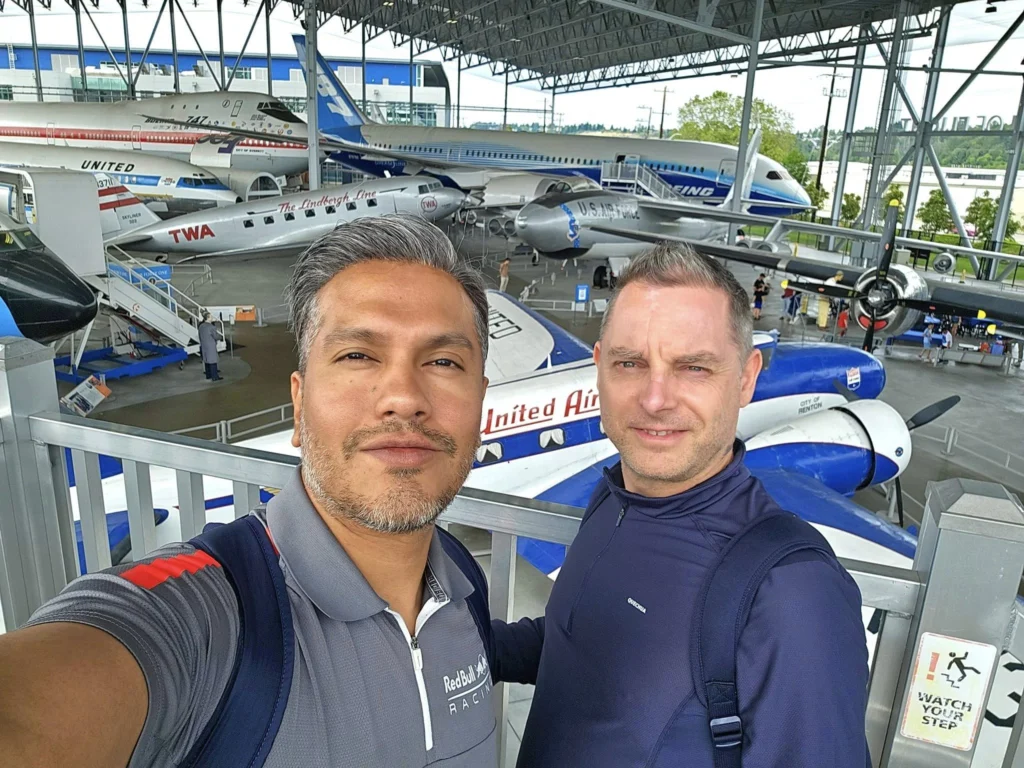 Cruising with Danny and Peter, Holland America Line, Westerdam, Seattle, Washington, United States, Day Trip Waterfalls History | A vibrant collage captures a day in Seattle’s Pacific Northwest Waterfalls Tour, showcasing Pike Place Market’s bustling scene with fishmongers tossing salmon and colorful flower stalls under the iconic red neon sign, set against Puget Sound’s waterfront; Twin Falls cascading over mossy cliffs into a misty pool, surrounded by old-growth evergreens in Olallie State Park, with sunlight filtering through the canopy; North Bend’s retro Twin Peaks diner with its glowing neon sign and quaint main street, framed by rolling hills and the Cascade Mountains; the majestic 270-foot Snoqualmie Falls roaring into a misty pool, with rainbows shimmering in the sunlight and a wooden viewing platform overlooking the lush Snoqualmie Valley; Snoqualmie’s historic district, featuring the Northwest Railway Museum’s vintage locomotives and charming shops lined with old-fashioned street lamps; Borst Lake’s serene waters reflecting Mount Si’s snow-capped peak, with a heron at the edge and evergreen forests under a soft morning mist; and the Museum of Flight’s sleek Concorde and Air Force One jets displayed in a spacious hangar, alongside interactive simulators and a replica of the International Space Station, showcasing Seattle’s aviation heritage.