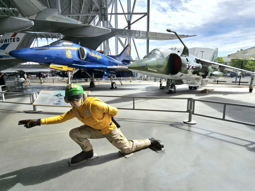 Cruising with Danny and Peter, Holland America Line, Westerdam, Seattle, Washington, United States, Day Trip Waterfalls History | A vibrant collage captures a day in Seattle’s Pacific Northwest Waterfalls Tour, showcasing Pike Place Market’s bustling scene with fishmongers tossing salmon and colorful flower stalls under the iconic red neon sign, set against Puget Sound’s waterfront; Twin Falls cascading over mossy cliffs into a misty pool, surrounded by old-growth evergreens in Olallie State Park, with sunlight filtering through the canopy; North Bend’s retro Twin Peaks diner with its glowing neon sign and quaint main street, framed by rolling hills and the Cascade Mountains; the majestic 270-foot Snoqualmie Falls roaring into a misty pool, with rainbows shimmering in the sunlight and a wooden viewing platform overlooking the lush Snoqualmie Valley; Snoqualmie’s historic district, featuring the Northwest Railway Museum’s vintage locomotives and charming shops lined with old-fashioned street lamps; Borst Lake’s serene waters reflecting Mount Si’s snow-capped peak, with a heron at the edge and evergreen forests under a soft morning mist; and the Museum of Flight’s sleek Concorde and Air Force One jets displayed in a spacious hangar, alongside interactive simulators and a replica of the International Space Station, showcasing Seattle’s aviation heritage.