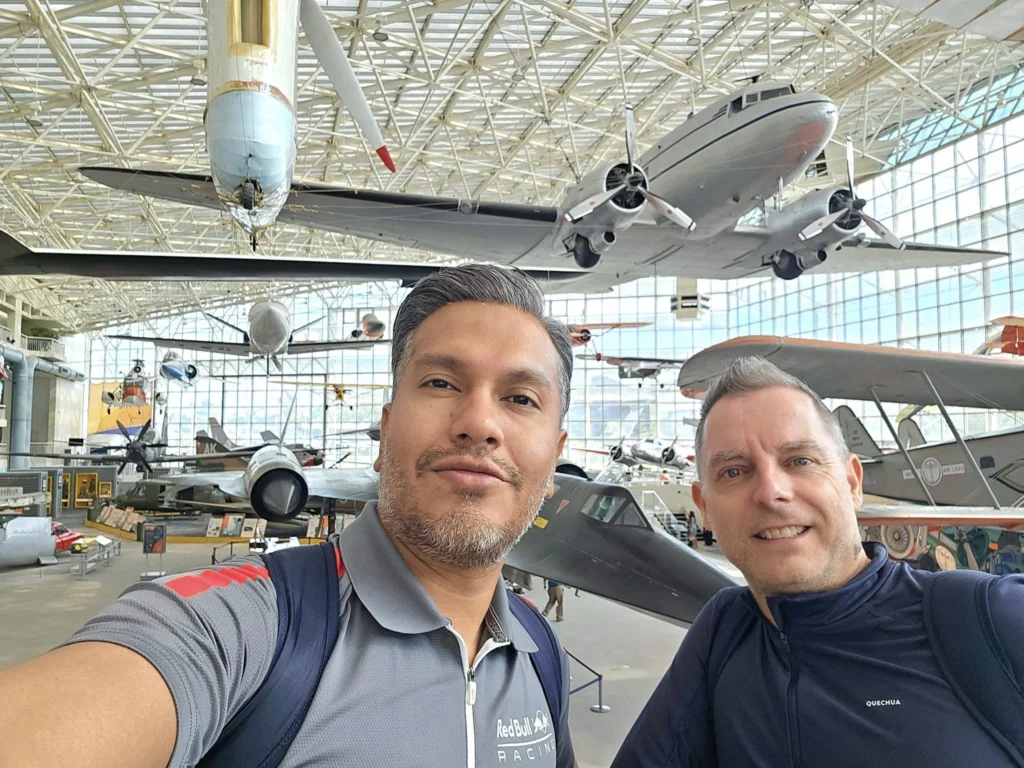 Cruising with Danny and Peter, Holland America Line, Westerdam, Seattle, Washington, United States, Day Trip Waterfalls History | A vibrant collage captures a day in Seattle’s Pacific Northwest Waterfalls Tour, showcasing Pike Place Market’s bustling scene with fishmongers tossing salmon and colorful flower stalls under the iconic red neon sign, set against Puget Sound’s waterfront; Twin Falls cascading over mossy cliffs into a misty pool, surrounded by old-growth evergreens in Olallie State Park, with sunlight filtering through the canopy; North Bend’s retro Twin Peaks diner with its glowing neon sign and quaint main street, framed by rolling hills and the Cascade Mountains; the majestic 270-foot Snoqualmie Falls roaring into a misty pool, with rainbows shimmering in the sunlight and a wooden viewing platform overlooking the lush Snoqualmie Valley; Snoqualmie’s historic district, featuring the Northwest Railway Museum’s vintage locomotives and charming shops lined with old-fashioned street lamps; Borst Lake’s serene waters reflecting Mount Si’s snow-capped peak, with a heron at the edge and evergreen forests under a soft morning mist; and the Museum of Flight’s sleek Concorde and Air Force One jets displayed in a spacious hangar, alongside interactive simulators and a replica of the International Space Station, showcasing Seattle’s aviation heritage.