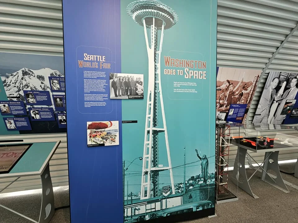 Cruising with Danny and Peter, Holland America Line, Westerdam, Seattle, Washington, United States, Day Trip Waterfalls History | A vibrant collage captures a day in Seattle’s Pacific Northwest Waterfalls Tour, showcasing Pike Place Market’s bustling scene with fishmongers tossing salmon and colorful flower stalls under the iconic red neon sign, set against Puget Sound’s waterfront; Twin Falls cascading over mossy cliffs into a misty pool, surrounded by old-growth evergreens in Olallie State Park, with sunlight filtering through the canopy; North Bend’s retro Twin Peaks diner with its glowing neon sign and quaint main street, framed by rolling hills and the Cascade Mountains; the majestic 270-foot Snoqualmie Falls roaring into a misty pool, with rainbows shimmering in the sunlight and a wooden viewing platform overlooking the lush Snoqualmie Valley; Snoqualmie’s historic district, featuring the Northwest Railway Museum’s vintage locomotives and charming shops lined with old-fashioned street lamps; Borst Lake’s serene waters reflecting Mount Si’s snow-capped peak, with a heron at the edge and evergreen forests under a soft morning mist; and the Museum of Flight’s sleek Concorde and Air Force One jets displayed in a spacious hangar, alongside interactive simulators and a replica of the International Space Station, showcasing Seattle’s aviation heritage.