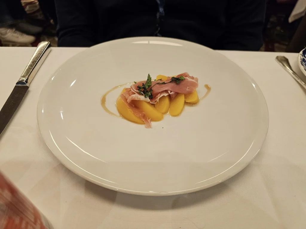 Cruising with Danny and Peter, Holland America Line, Westerdam, Inside Passage, Alaska, United States | Westerdam luxury cruise ship sailing through the Inside Passage, with majestic glaciers and dramatic landscapes in view. The image features an elegant stateroom with a spacious veranda, offering panoramic scenery, and highlights gourmet dining and an informative lecture by onboard naturalists, showcasing the comprehensive luxury and educational experience of the cruise.