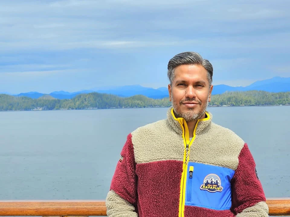 Cruising with Danny and Peter, Holland America Line, Westerdam, Inside Passage, Alaska, United States | Westerdam luxury cruise ship sailing through the Inside Passage, with majestic glaciers and dramatic landscapes in view. The image features an elegant stateroom with a spacious veranda, offering panoramic scenery, and highlights gourmet dining and an informative lecture by onboard naturalists, showcasing the comprehensive luxury and educational experience of the cruise.