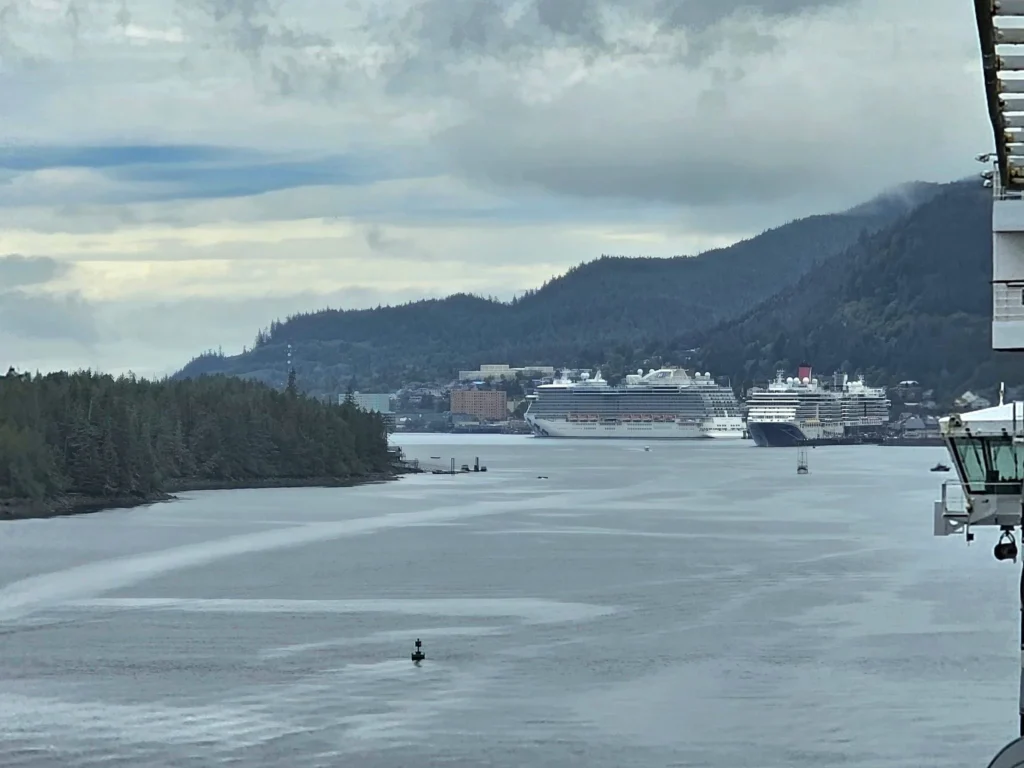 Cruising with Danny and Peter, Holland America Line, Westerdam, Ketchikan, Alaska, United States, Adventure History Thrills | A vibrant collage capturing the Ketchikan Adventure Tour in Alaska, featuring a dynamic log-rolling contest at the Great Alaskan Lumberjack Show with lumberjacks in plaid shirts balancing on a floating log, a rugged UTV navigating a muddy trail through the Tongass National Forest with George Inlet Fjords’ turquoise waters in view, a serene scenic cruise along the Inside Passage with a bald eagle soaring above mist-covered mountains, and a cozy scene at George Inlet Lodge with a rustic table set with craft beers, creamy crab chowder, hot Dungeness crab, and blueberry cheesecake. In the background, Ketchikan’s historic Creek Street showcases colorful buildings on stilts and a Tlingit totem pole, framed by lush greenery and rugged Alaskan peaks, embodying the city’s thrilling adventures and rich cultural heritage.
