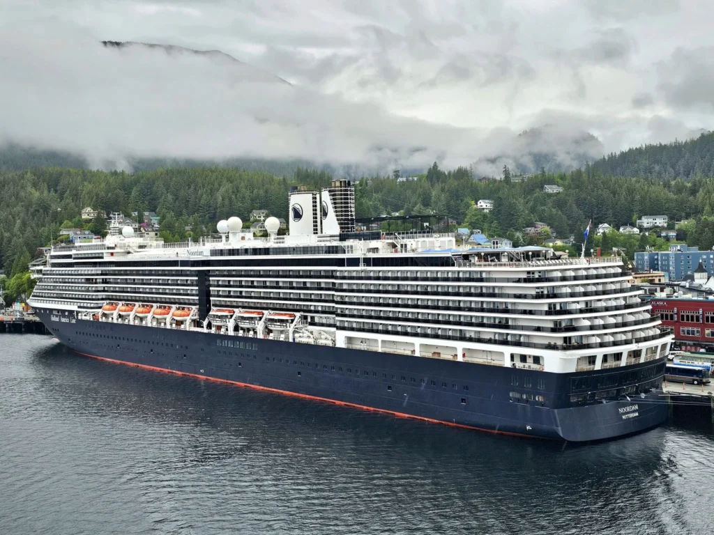 Cruising with Danny and Peter, Holland America Line, Westerdam, Ketchikan, Alaska, United States, Adventure History Thrills | A vibrant collage capturing the Ketchikan Adventure Tour in Alaska, featuring a dynamic log-rolling contest at the Great Alaskan Lumberjack Show with lumberjacks in plaid shirts balancing on a floating log, a rugged UTV navigating a muddy trail through the Tongass National Forest with George Inlet Fjords’ turquoise waters in view, a serene scenic cruise along the Inside Passage with a bald eagle soaring above mist-covered mountains, and a cozy scene at George Inlet Lodge with a rustic table set with craft beers, creamy crab chowder, hot Dungeness crab, and blueberry cheesecake. In the background, Ketchikan’s historic Creek Street showcases colorful buildings on stilts and a Tlingit totem pole, framed by lush greenery and rugged Alaskan peaks, embodying the city’s thrilling adventures and rich cultural heritage.