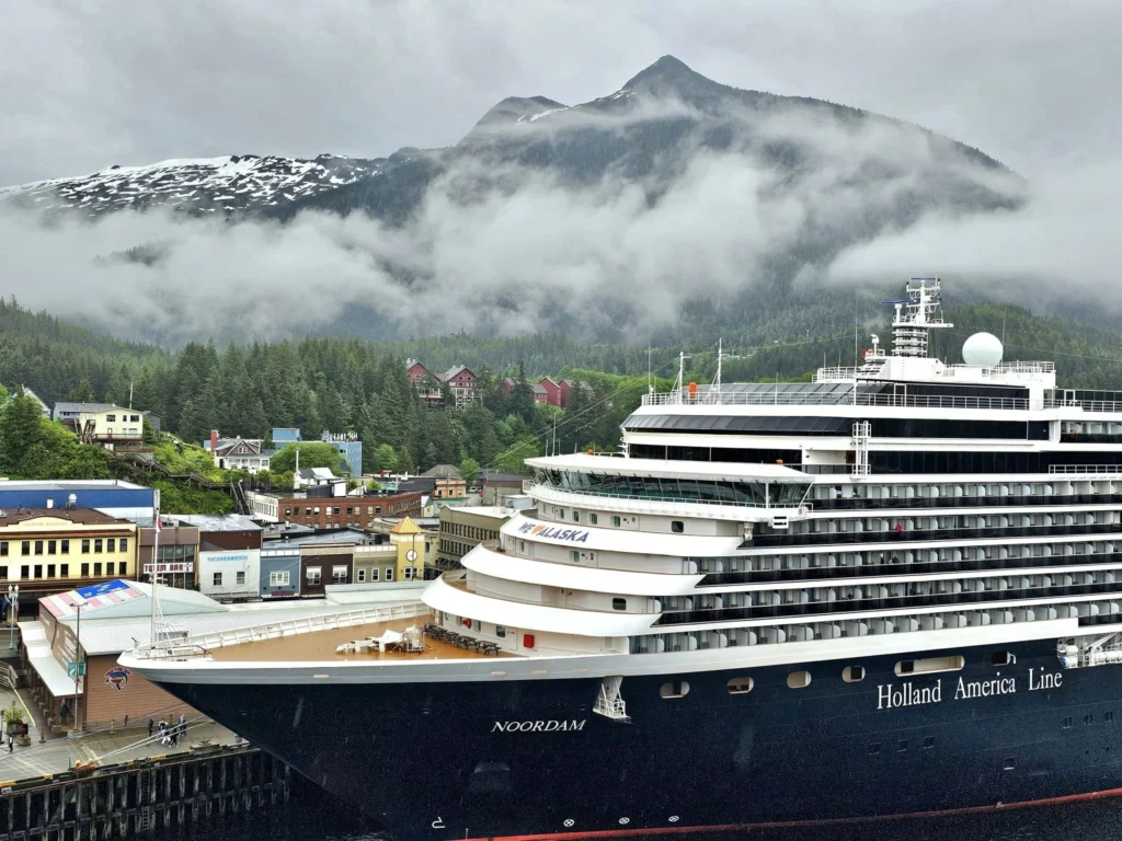 Cruising with Danny and Peter, Holland America Line, Westerdam, Ketchikan, Alaska, United States, Adventure History Thrills | A vibrant collage capturing the Ketchikan Adventure Tour in Alaska, featuring a dynamic log-rolling contest at the Great Alaskan Lumberjack Show with lumberjacks in plaid shirts balancing on a floating log, a rugged UTV navigating a muddy trail through the Tongass National Forest with George Inlet Fjords’ turquoise waters in view, a serene scenic cruise along the Inside Passage with a bald eagle soaring above mist-covered mountains, and a cozy scene at George Inlet Lodge with a rustic table set with craft beers, creamy crab chowder, hot Dungeness crab, and blueberry cheesecake. In the background, Ketchikan’s historic Creek Street showcases colorful buildings on stilts and a Tlingit totem pole, framed by lush greenery and rugged Alaskan peaks, embodying the city’s thrilling adventures and rich cultural heritage.