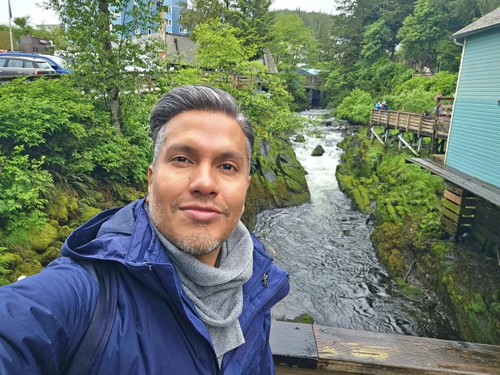 Cruising with Danny and Peter, Holland America Line, Westerdam, Ketchikan, Alaska, United States, Adventure History Thrills | A vibrant collage capturing the Ketchikan Adventure Tour in Alaska, featuring a dynamic log-rolling contest at the Great Alaskan Lumberjack Show with lumberjacks in plaid shirts balancing on a floating log, a rugged UTV navigating a muddy trail through the Tongass National Forest with George Inlet Fjords’ turquoise waters in view, a serene scenic cruise along the Inside Passage with a bald eagle soaring above mist-covered mountains, and a cozy scene at George Inlet Lodge with a rustic table set with craft beers, creamy crab chowder, hot Dungeness crab, and blueberry cheesecake. In the background, Ketchikan’s historic Creek Street showcases colorful buildings on stilts and a Tlingit totem pole, framed by lush greenery and rugged Alaskan peaks, embodying the city’s thrilling adventures and rich cultural heritage.