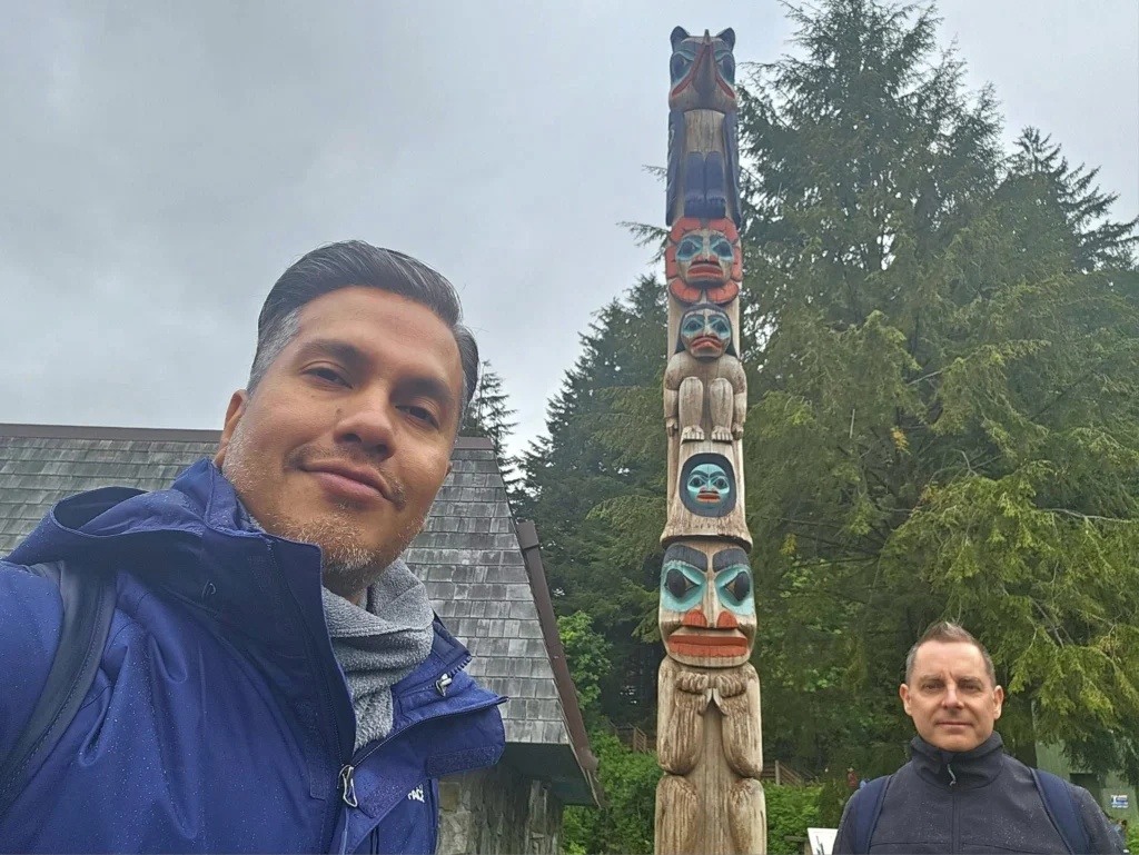 Cruising with Danny and Peter, Holland America Line, Westerdam, Ketchikan, Alaska, United States, Adventure History Thrills | A vibrant collage capturing the Ketchikan Adventure Tour in Alaska, featuring a dynamic log-rolling contest at the Great Alaskan Lumberjack Show with lumberjacks in plaid shirts balancing on a floating log, a rugged UTV navigating a muddy trail through the Tongass National Forest with George Inlet Fjords’ turquoise waters in view, a serene scenic cruise along the Inside Passage with a bald eagle soaring above mist-covered mountains, and a cozy scene at George Inlet Lodge with a rustic table set with craft beers, creamy crab chowder, hot Dungeness crab, and blueberry cheesecake. In the background, Ketchikan’s historic Creek Street showcases colorful buildings on stilts and a Tlingit totem pole, framed by lush greenery and rugged Alaskan peaks, embodying the city’s thrilling adventures and rich cultural heritage.