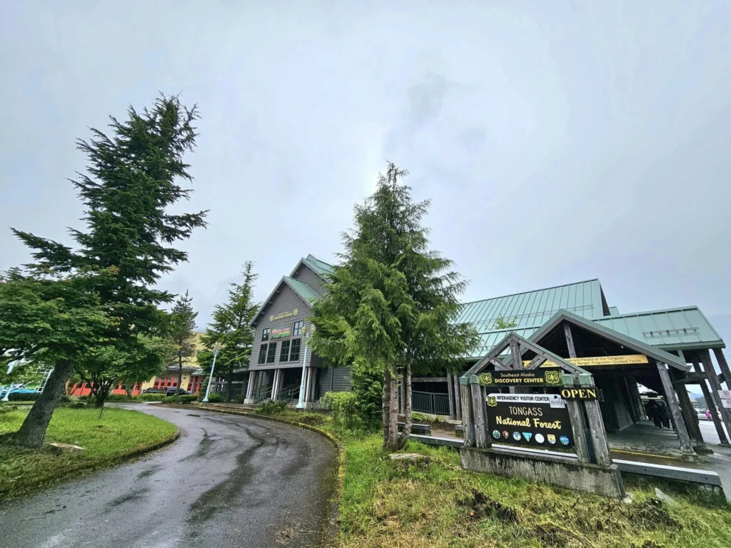 Cruising with Danny and Peter, Holland America Line, Westerdam, Ketchikan, Alaska, United States, Adventure History Thrills | A vibrant collage capturing the Ketchikan Adventure Tour in Alaska, featuring a dynamic log-rolling contest at the Great Alaskan Lumberjack Show with lumberjacks in plaid shirts balancing on a floating log, a rugged UTV navigating a muddy trail through the Tongass National Forest with George Inlet Fjords’ turquoise waters in view, a serene scenic cruise along the Inside Passage with a bald eagle soaring above mist-covered mountains, and a cozy scene at George Inlet Lodge with a rustic table set with craft beers, creamy crab chowder, hot Dungeness crab, and blueberry cheesecake. In the background, Ketchikan’s historic Creek Street showcases colorful buildings on stilts and a Tlingit totem pole, framed by lush greenery and rugged Alaskan peaks, embodying the city’s thrilling adventures and rich cultural heritage.