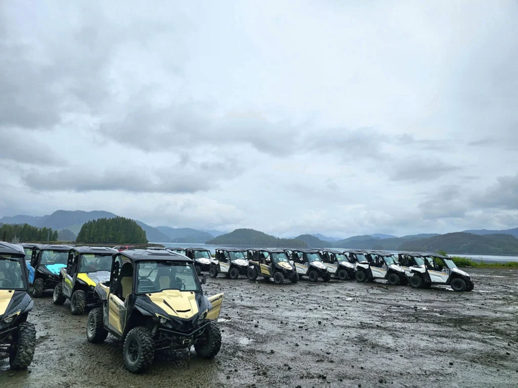 Cruising with Danny and Peter, Holland America Line, Westerdam, Ketchikan, Alaska, United States, Adventure History Thrills | A vibrant collage capturing the Ketchikan Adventure Tour in Alaska, featuring a dynamic log-rolling contest at the Great Alaskan Lumberjack Show with lumberjacks in plaid shirts balancing on a floating log, a rugged UTV navigating a muddy trail through the Tongass National Forest with George Inlet Fjords’ turquoise waters in view, a serene scenic cruise along the Inside Passage with a bald eagle soaring above mist-covered mountains, and a cozy scene at George Inlet Lodge with a rustic table set with craft beers, creamy crab chowder, hot Dungeness crab, and blueberry cheesecake. In the background, Ketchikan’s historic Creek Street showcases colorful buildings on stilts and a Tlingit totem pole, framed by lush greenery and rugged Alaskan peaks, embodying the city’s thrilling adventures and rich cultural heritage.