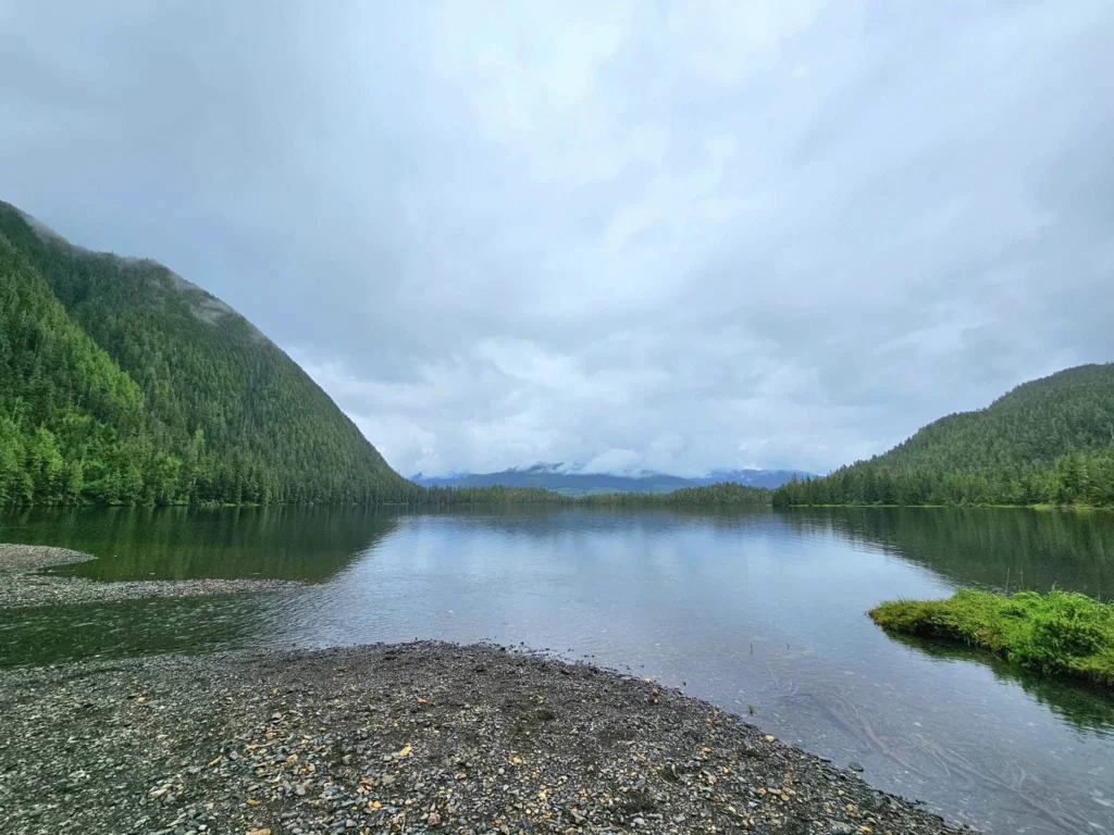 Cruising with Danny and Peter, Holland America Line, Westerdam, Ketchikan, Alaska, United States, Adventure History Thrills | A vibrant collage capturing the Ketchikan Adventure Tour in Alaska, featuring a dynamic log-rolling contest at the Great Alaskan Lumberjack Show with lumberjacks in plaid shirts balancing on a floating log, a rugged UTV navigating a muddy trail through the Tongass National Forest with George Inlet Fjords’ turquoise waters in view, a serene scenic cruise along the Inside Passage with a bald eagle soaring above mist-covered mountains, and a cozy scene at George Inlet Lodge with a rustic table set with craft beers, creamy crab chowder, hot Dungeness crab, and blueberry cheesecake. In the background, Ketchikan’s historic Creek Street showcases colorful buildings on stilts and a Tlingit totem pole, framed by lush greenery and rugged Alaskan peaks, embodying the city’s thrilling adventures and rich cultural heritage.