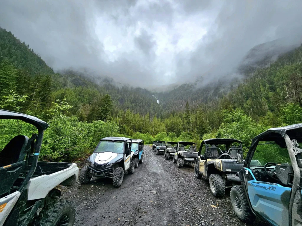 Cruising with Danny and Peter, Holland America Line, Westerdam, Ketchikan, Alaska, United States, Adventure History Thrills | A vibrant collage capturing the Ketchikan Adventure Tour in Alaska, featuring a dynamic log-rolling contest at the Great Alaskan Lumberjack Show with lumberjacks in plaid shirts balancing on a floating log, a rugged UTV navigating a muddy trail through the Tongass National Forest with George Inlet Fjords’ turquoise waters in view, a serene scenic cruise along the Inside Passage with a bald eagle soaring above mist-covered mountains, and a cozy scene at George Inlet Lodge with a rustic table set with craft beers, creamy crab chowder, hot Dungeness crab, and blueberry cheesecake. In the background, Ketchikan’s historic Creek Street showcases colorful buildings on stilts and a Tlingit totem pole, framed by lush greenery and rugged Alaskan peaks, embodying the city’s thrilling adventures and rich cultural heritage.